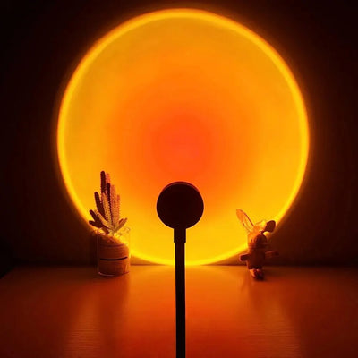 USB sunset lamp projecting warm orange glow in bedroom